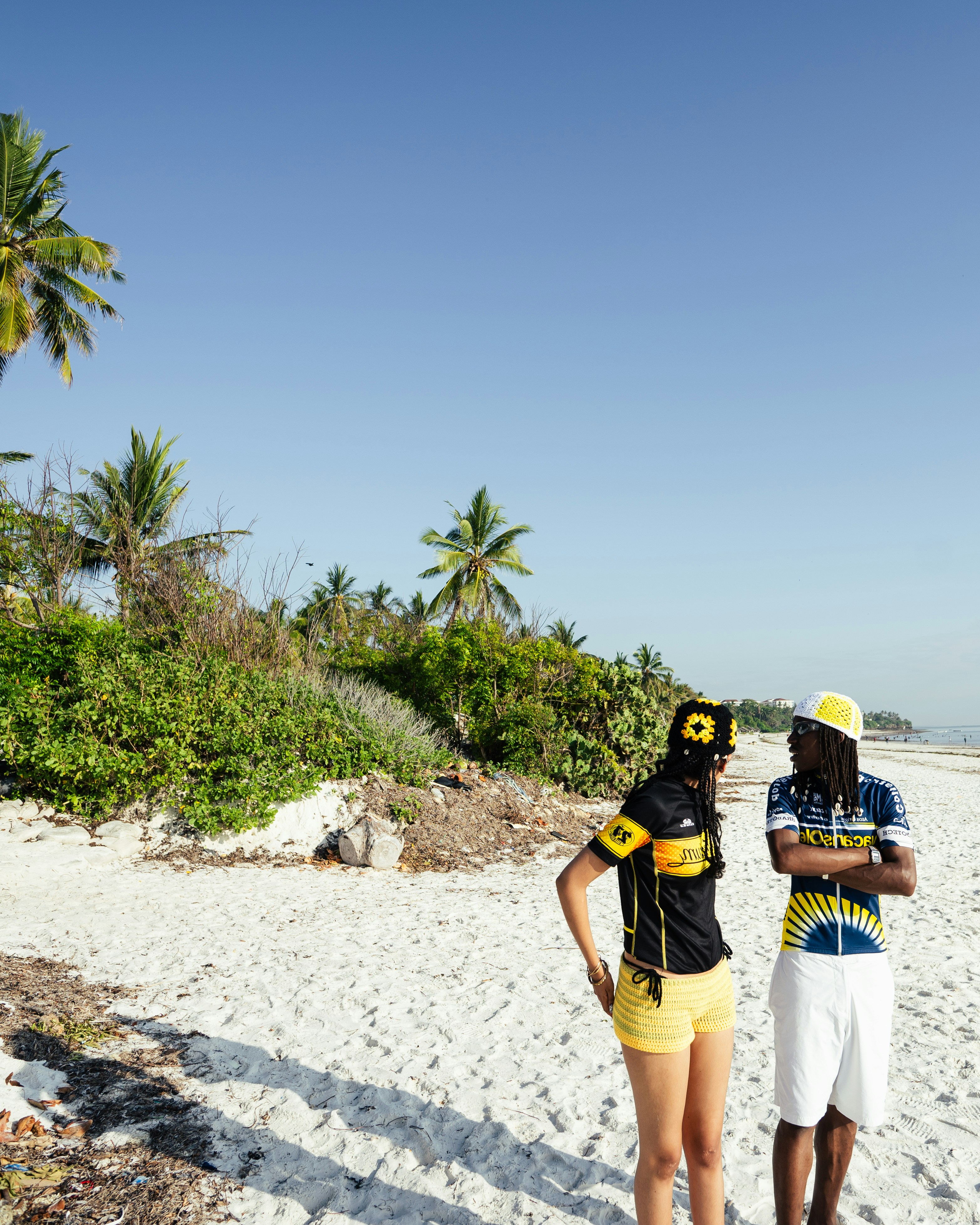 Travellers walking beside clear blue water
